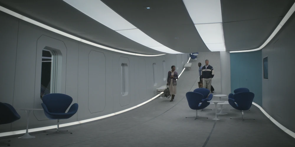 Screenshot from the TV show For All Mankind, three people inside the spinning Polaris orbiting hotel